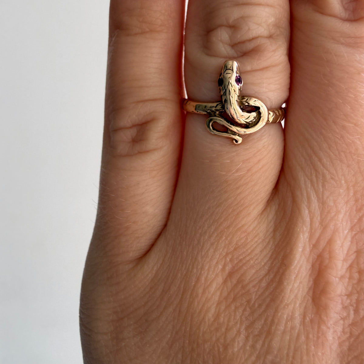 V I N T A G E // knotted embrace / 10k yellow gold snake ring with ruby eyes / size 4.5